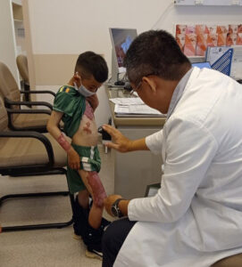 Surgical restoration of arm function for a 6-year-old boy following contracture due to burns